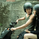 A young couple rides on a scooter together in The Sadness.